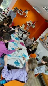 dzieci splatają kolejną część ramki